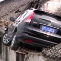 See out-of-control SUV crash onto house’s roof